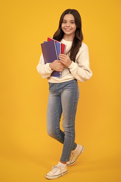 Aluna com livro de cópia posando em fundo isolado Lição de literatura escola de gramática Leitor de criança intelectual Rosto feliz emoções positivas e sorridentes de adolescente