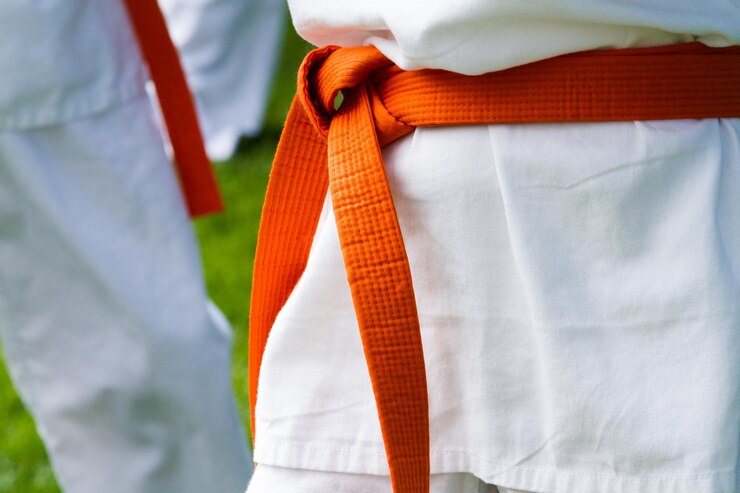 Foto aluno de tae kwon do praticando no parque.