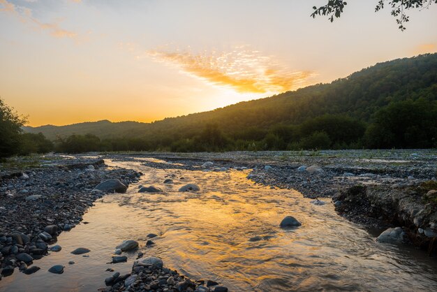 Foto amanecer colorido en el río de la montaña