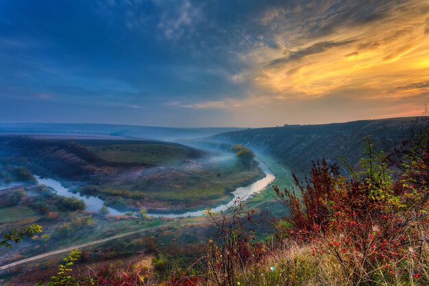 Amanecer sobre un pequeño río brumoso