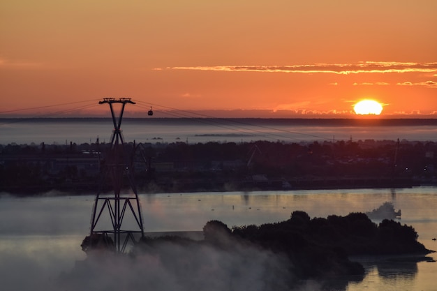 amanecer sobre el teleférico que cruza el río