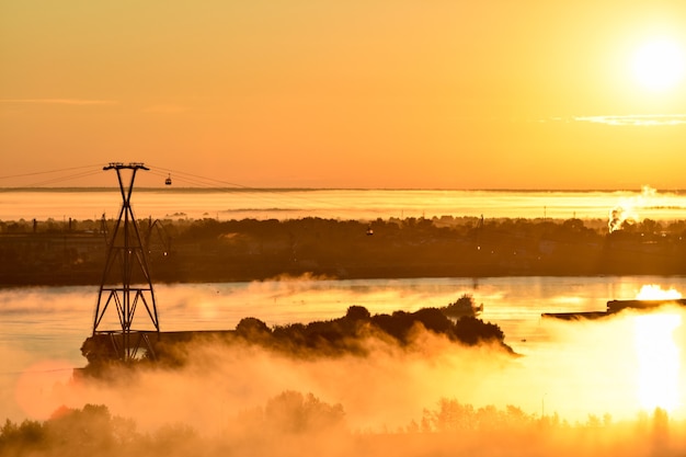 amanecer sobre el teleférico que cruza el río