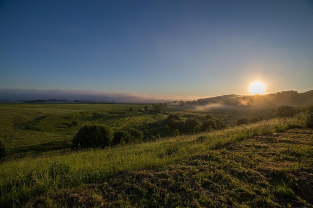 Amanecer de verano con niebla distante en medio de la nada