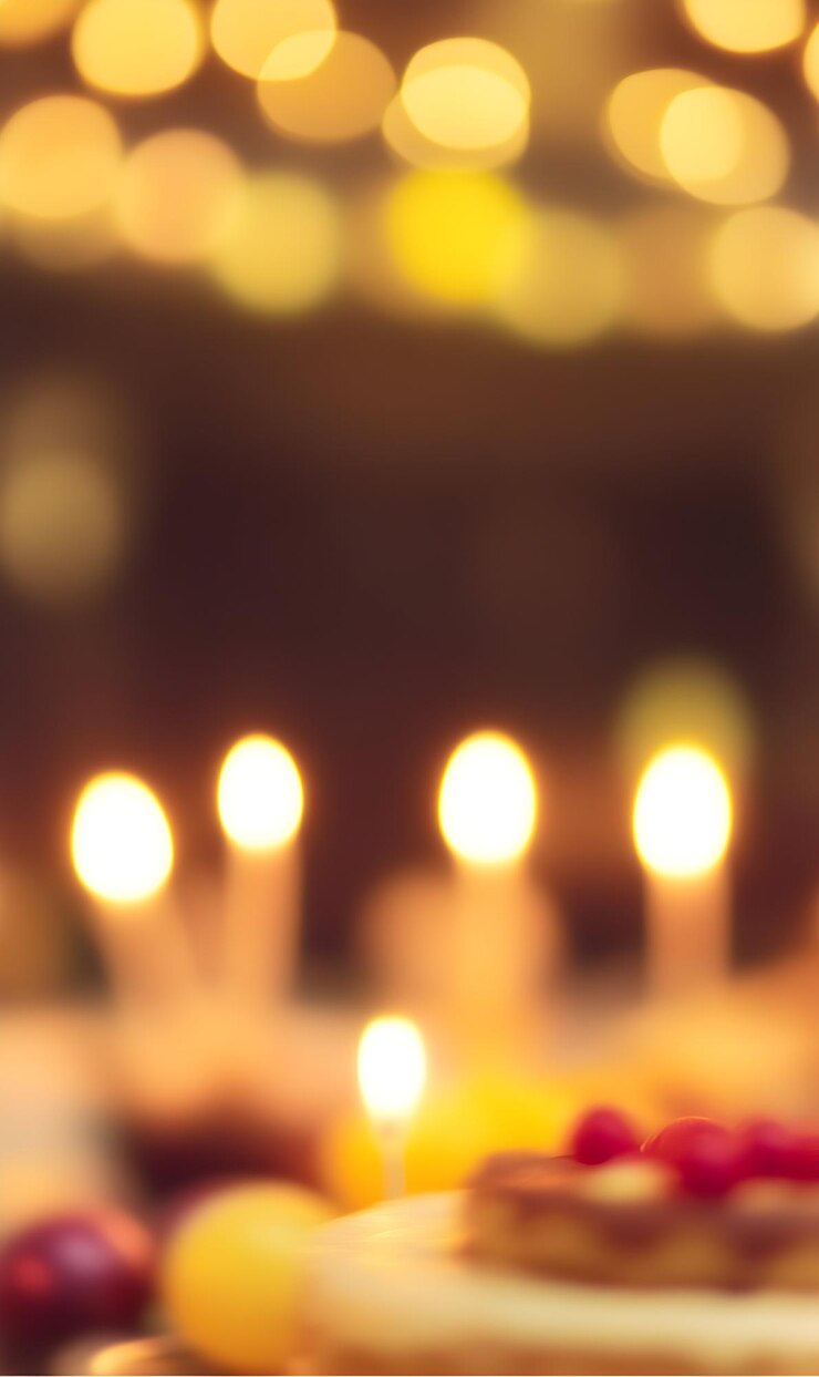 Un ambiente festivo borroso con velas encendidas y pastel que crea una sensación acogedora y cálida