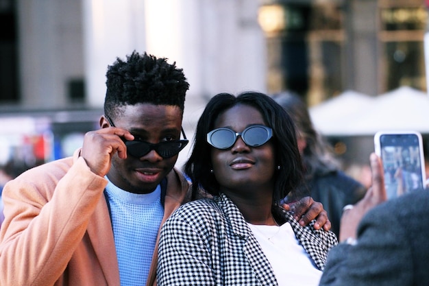 Amigo a fotografar um jovem casal na cidade.