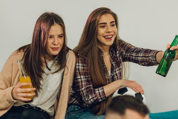 Amigos assistindo jogo de futebol em casa e torcendo