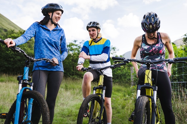 Foto amigos en bicicleta juntos en el campo.