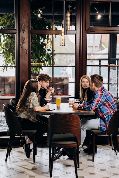 Amigos brindando y bebiendo cerveza y cócteles en el concepto de tiempo de fiesta de estilo de vida de restaurante pub