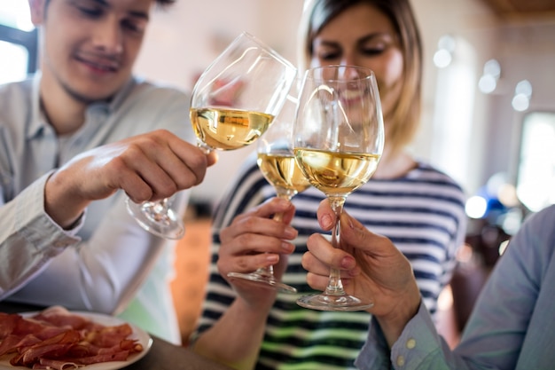 Amigos brindando um copo de vinho no bar