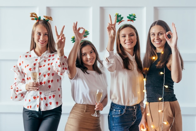 Amigos comemorando a festa de véspera de Natal ou ano novo mostrando gestos 2020.