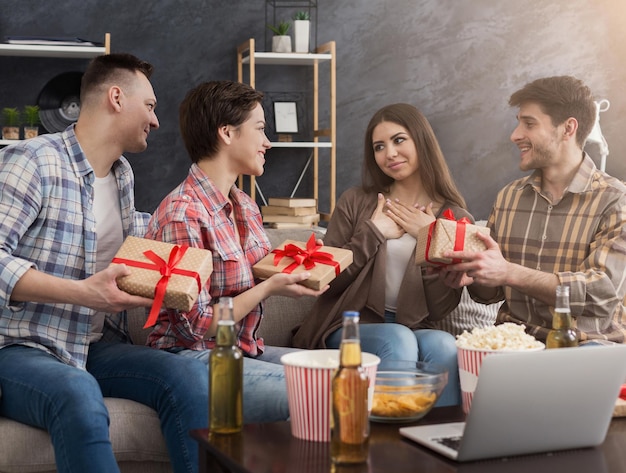 Amigos comemorando aniversário e dando presentes para a garota em casa