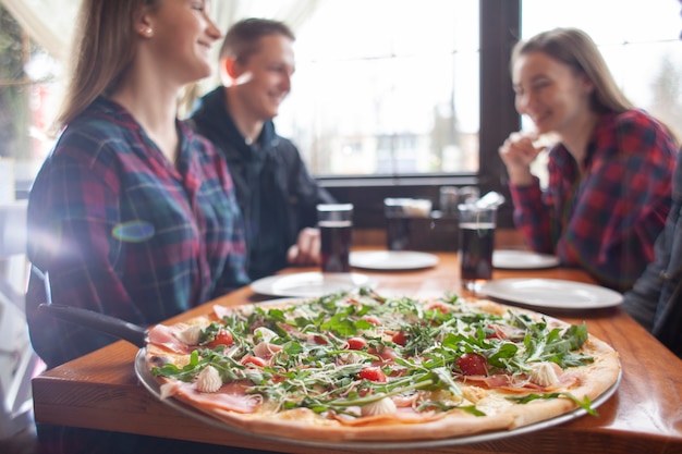 Foto amigos comiendo pizza juntos