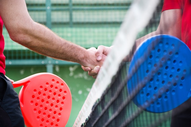 amigos dándose la mano en el pádel