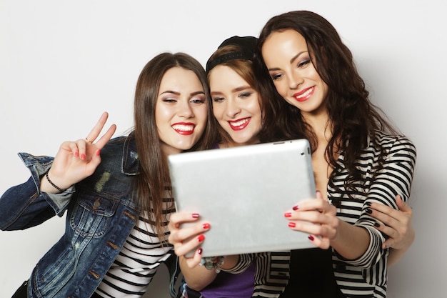 Amigos de meninas tomando selfie com tablet digital