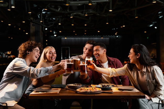 Amigos de tiro médio com canecas de cerveja