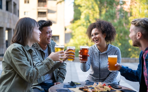 Amigos felizes se divertindo grupo de amigos da geração do milênio torcendo pelo esporte no bar juntos