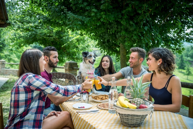 Amigos felizes tomando café da manhã em uma casa de campo