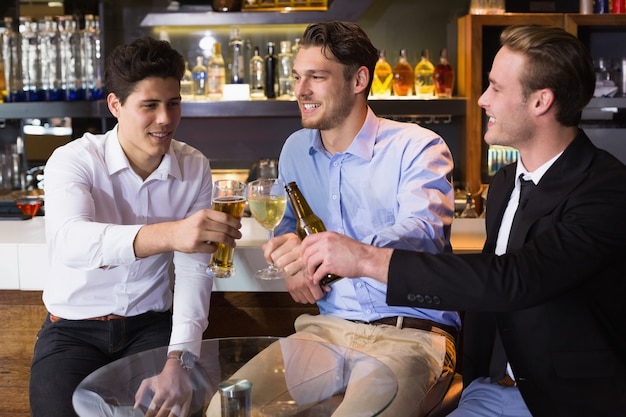 Amigos guapos tomando un trago juntos