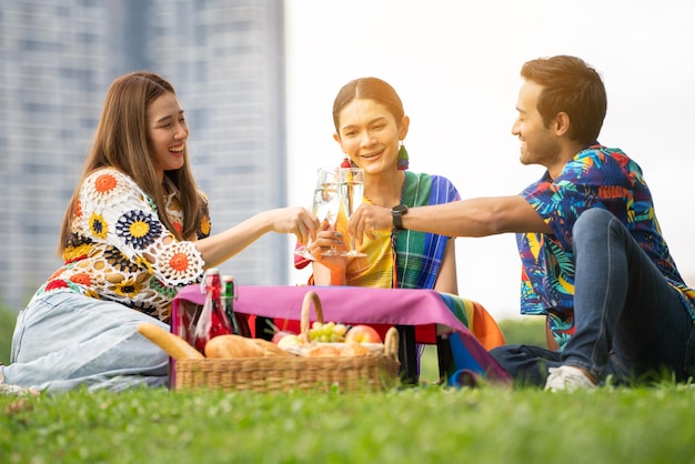 Amigos LGBTQ fazem piquenique Jovens amigos felizes fazendo piquenique no Parque da cidadePessoas saindo sorrindo