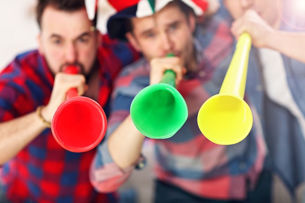 amigos masculinos felizes torcendo e assistindo esportes na tv