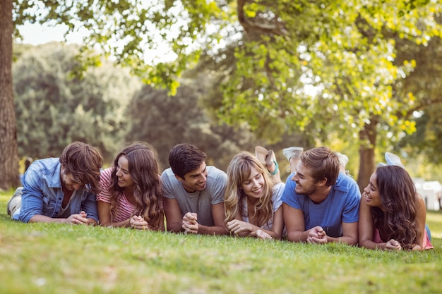 Amigos mintiendo y hablando en el parque