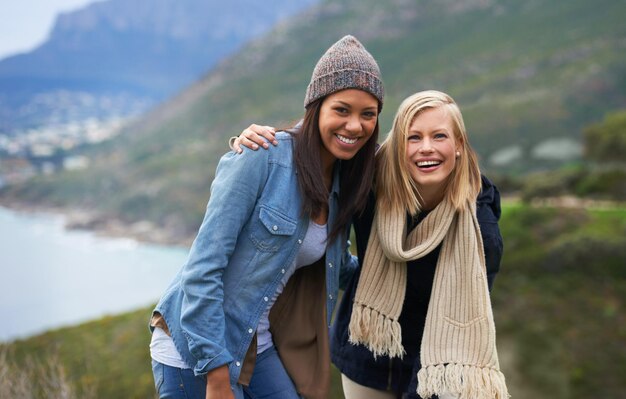 Amigos retrato e mulheres na montanha para aventura em férias férias e fim de semana ao ar livre Viagens na natureza e pessoas à beira-mar para relaxar felicidade e ligação juntos no campo