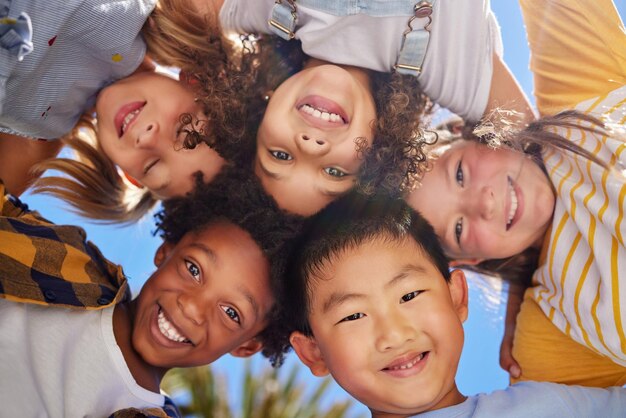 Amigos sonriendo y debajo retrato de niños al aire libre para el fin de semana de vacaciones de verano y jugando juegos juntos Amistad infantil y grupo de niños en círculo para la diversidad comunidad y apoyo