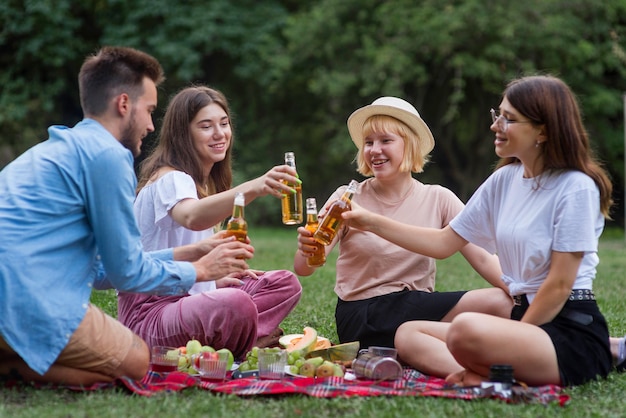 Foto amigos de tiro completo brindando en un picnic