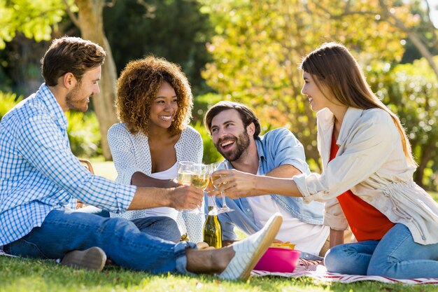 Amigos tostando copas de vino mientras desayuna