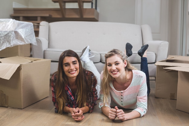 Foto amigos tumbados juntos en el suelo y sonriendo