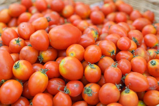 Foto amontoando pilhas de tomates frescos e maduros