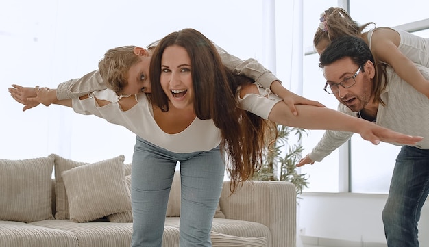 Amorosos padres jugando con niños en su hogar el concepto de educación