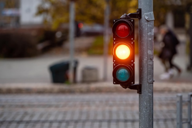 Ampel an der Straßenkreuzung mit schöner Bokeh-Stadt mit Autos im Hintergrund