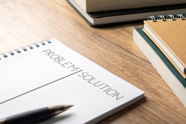 An open notebook with PROBLEM and SOLUTION written on its pages Problem solving strategic thinking