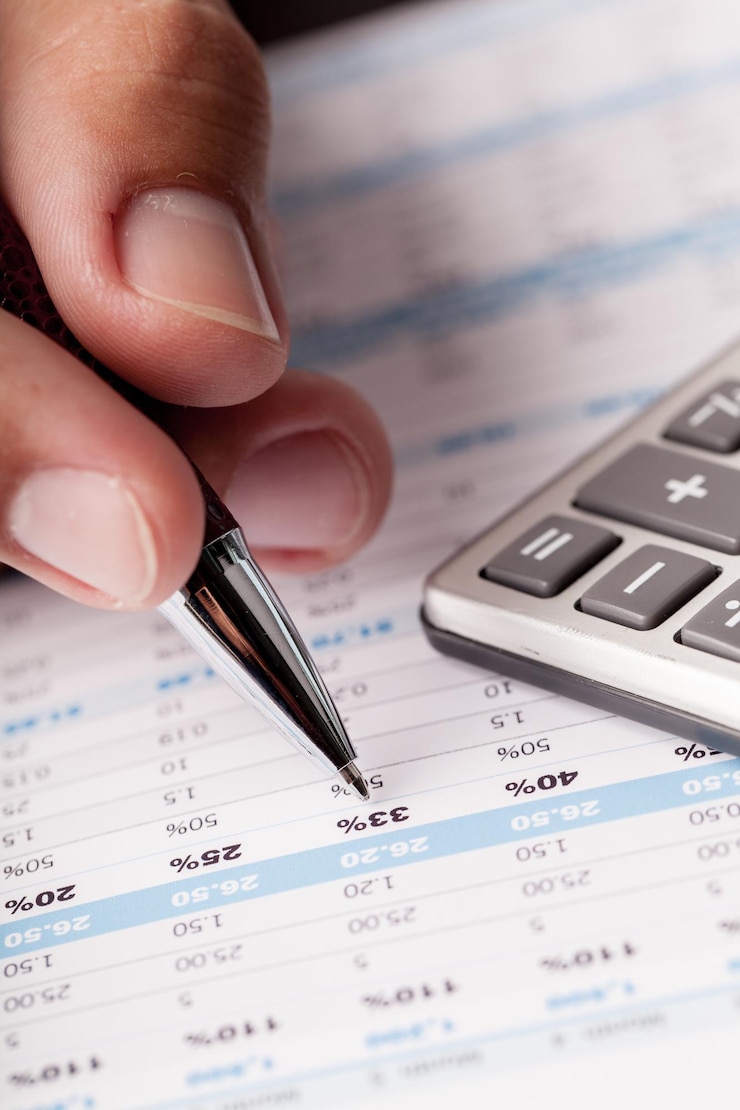 Foto análise de dados financeiros. foto de close-up da mão de um empresário contando com calculadora no escritório.