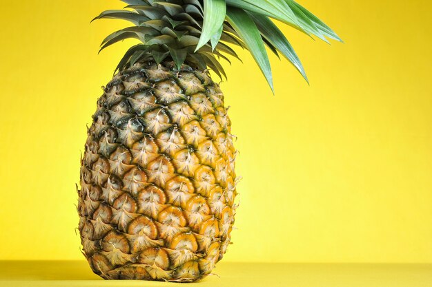 Ananas auf leuchtend gelbem Hintergrund. Frische Ananas auf leuchtend gelbem Hintergrund. Sommerfrucht.