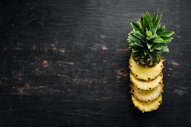 Ananas Geschnittene Ananas auf einem hölzernen Hintergrund Draufsicht Freier Kopierplatz