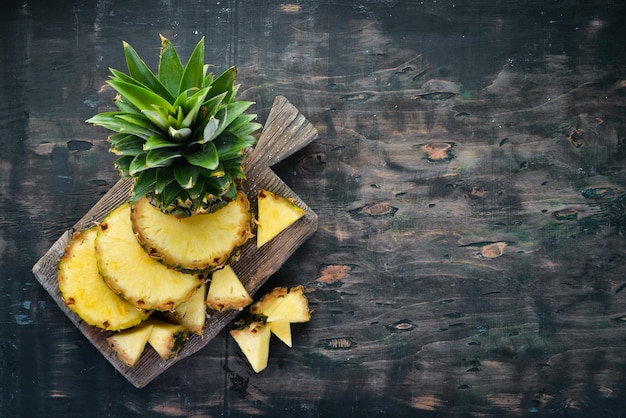 Ananas Geschnittene Ananas auf einem hölzernen Hintergrund Draufsicht Freier Kopierplatz