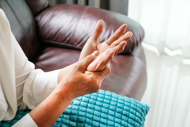 Foto anciana sufre de dolor de mano de muñeca, concepto de problema de salud