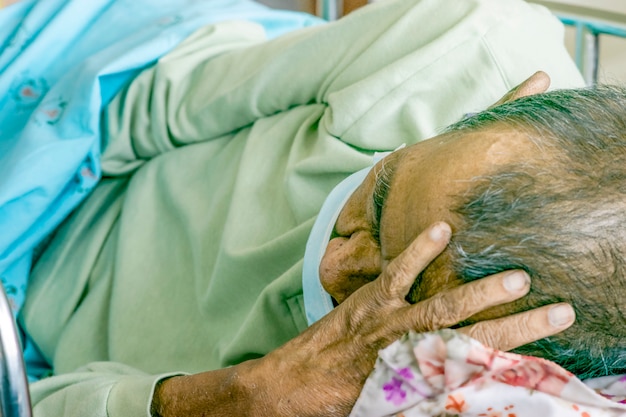 Foto anciano enfermo en la cama en un hospital.