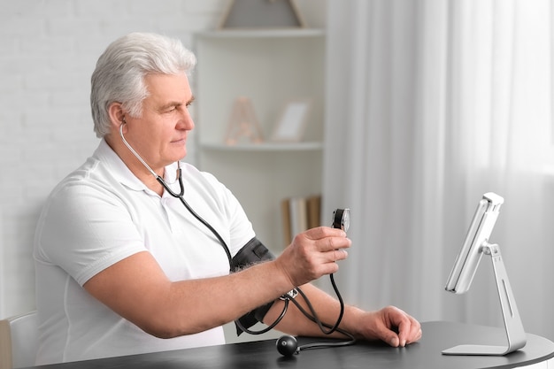 Anciano video chat con médico en casa