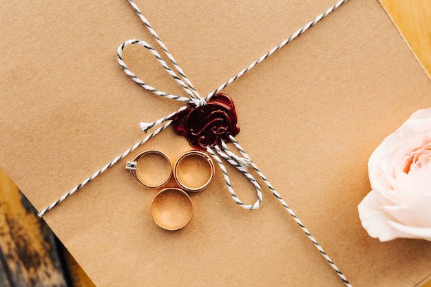 Anéis de ouro em embalagens de artesanato com um selo de cera vermelha