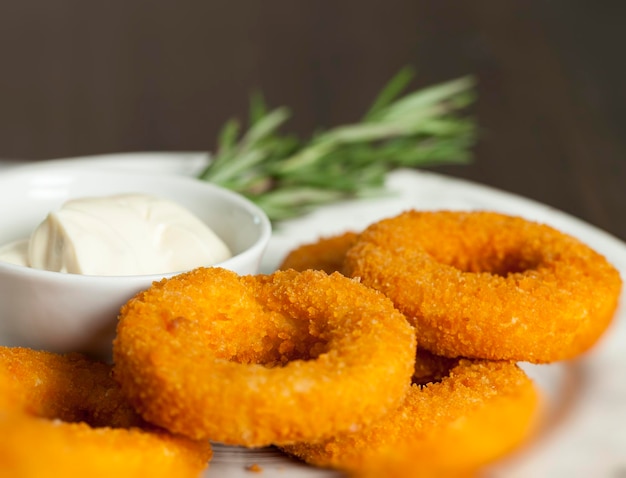 Anéis de queijo frito com molho cremoso de alho, pratos de restaurante feitos de queijo com molho