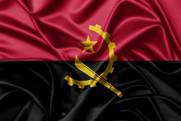 Angola ondeando la bandera cerca de fondo de textura satinada