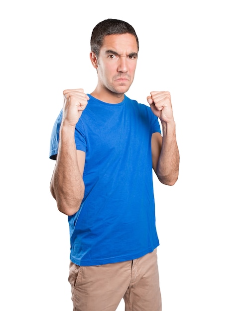 Angry young man against white background