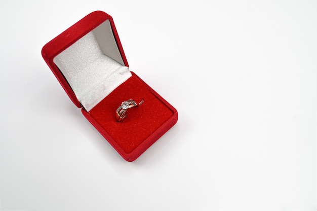 Anillo de joyería con diamante en caja roja.