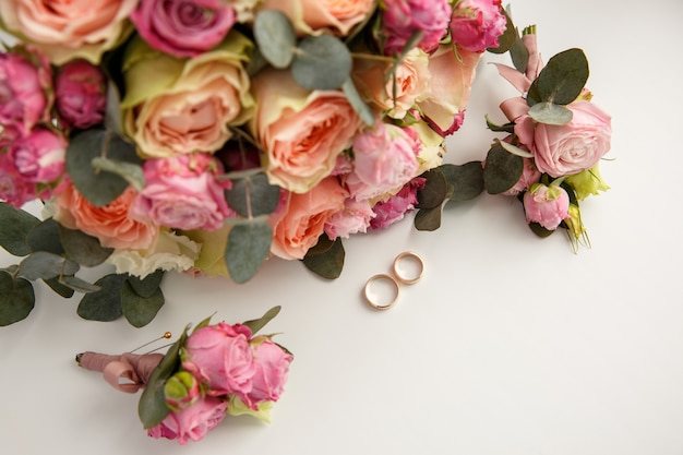 Anillos de boda cerca de ramo de boda