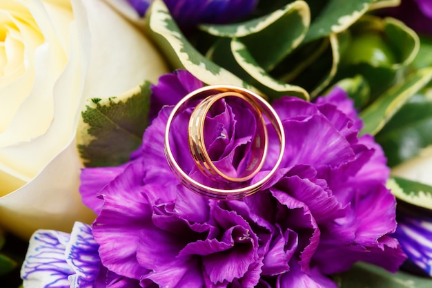 Foto anillos de boda en ramo de flores de novia