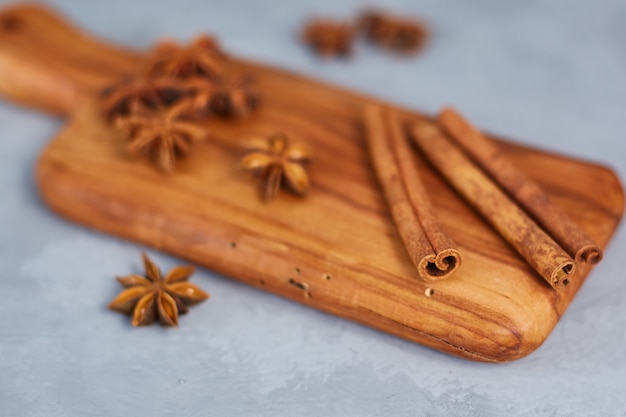 Anís estrellado, canela sobre una plancha de madera. De cerca.