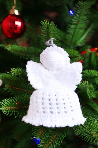 Anjos de natal tricotados e outras decorações no fundo da árvore de natal, close-up